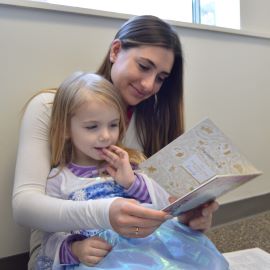 Woman reading to young child