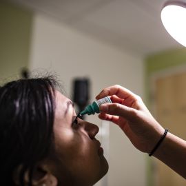 woman getting eye drops 