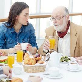 Family breakfast with young woman & older man