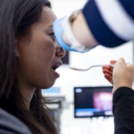 Woman being fed for swallowing testing