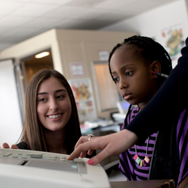 girl getting her hearing tested by audiologist
