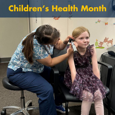 child getting her ear examined