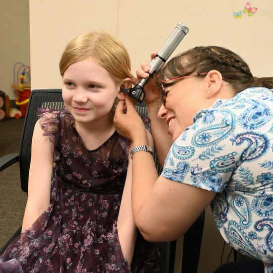 child getting their hearing examined