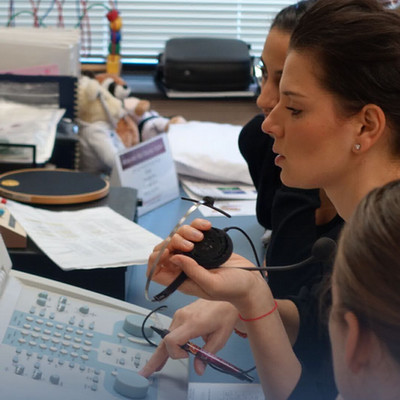 audiologist conducting hearing test
