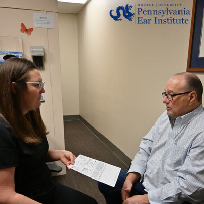 audiologist providing literature to patient