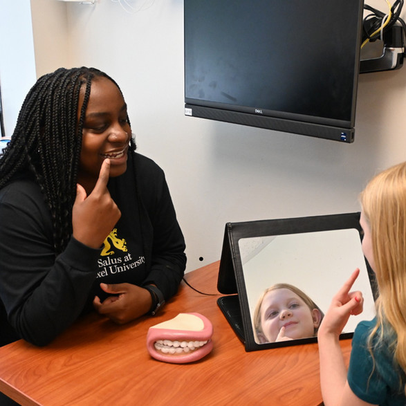 SLP and patient pointing at their mouths