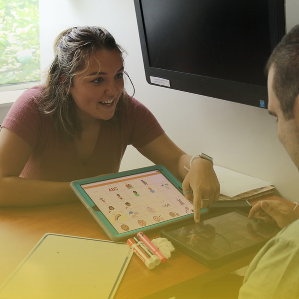 SLP pointing at iPad with client