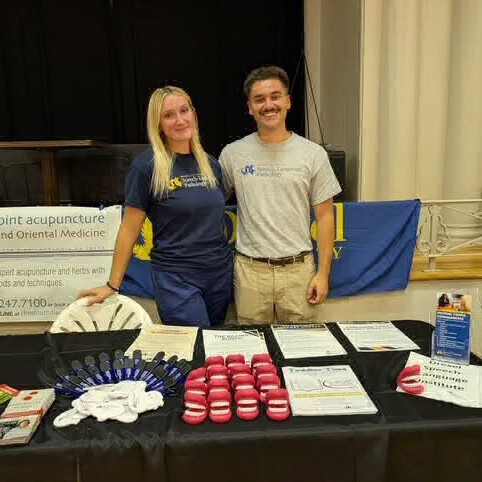 SLP students behind information table