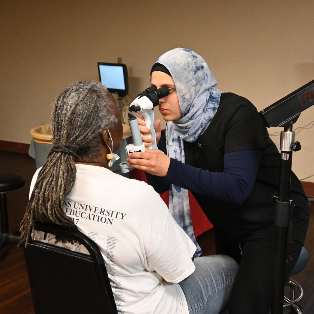 student giving eye exam