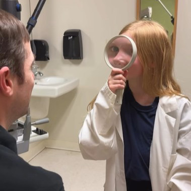 child holding a magnifying glass