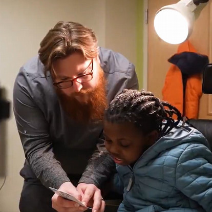 optometry student conducting vision exam on child