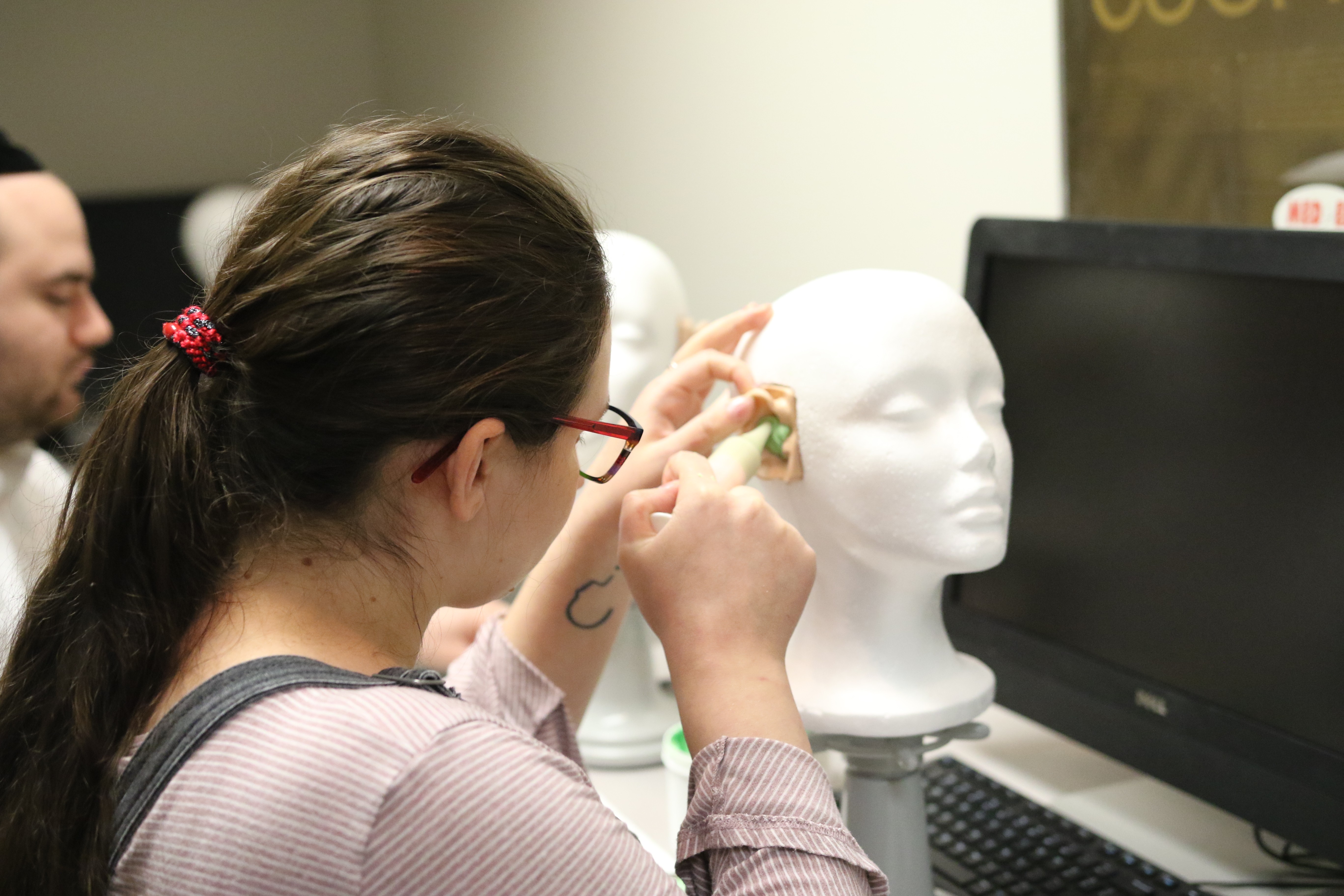 Student making ear molds in lab