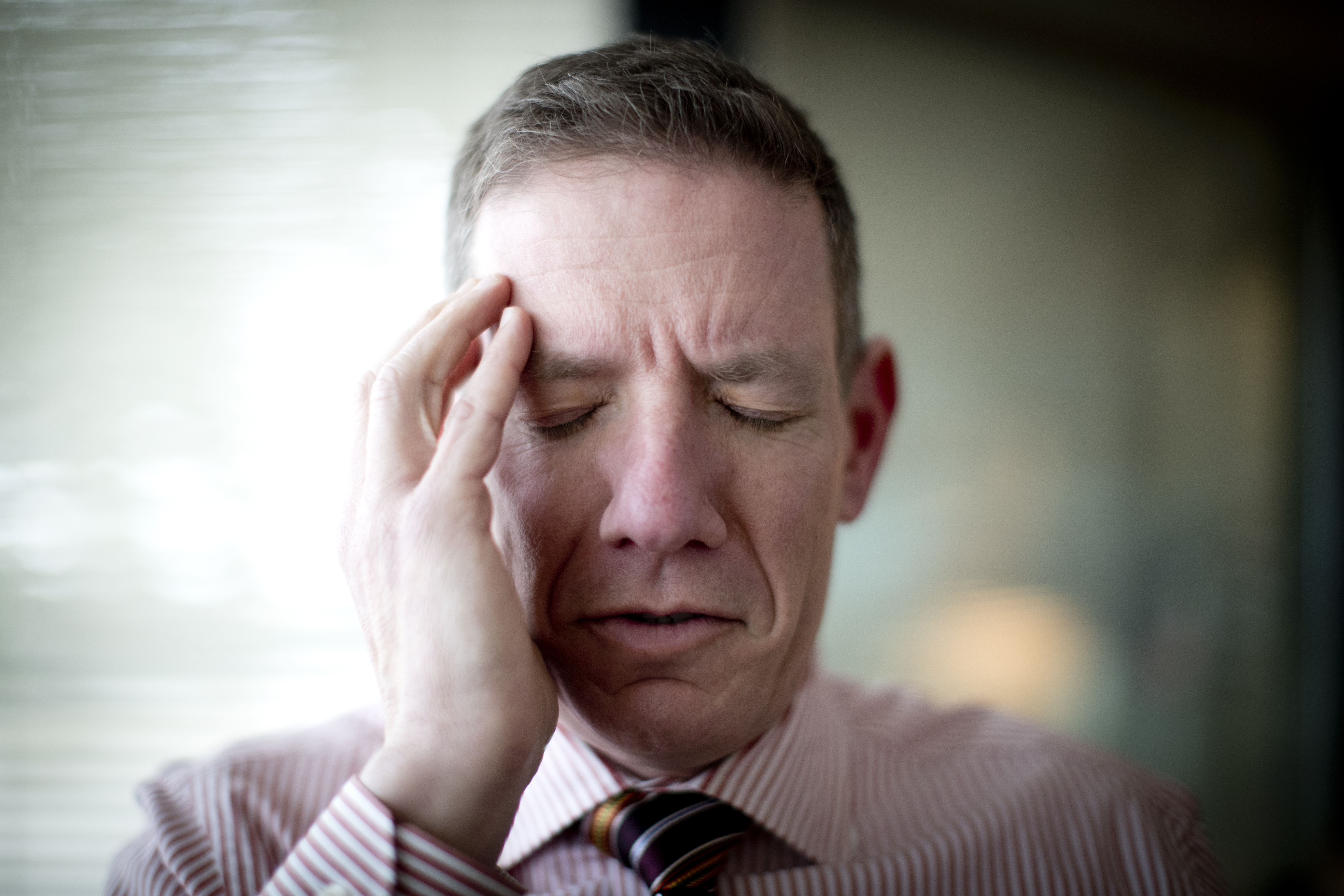 Man holding his head in pain