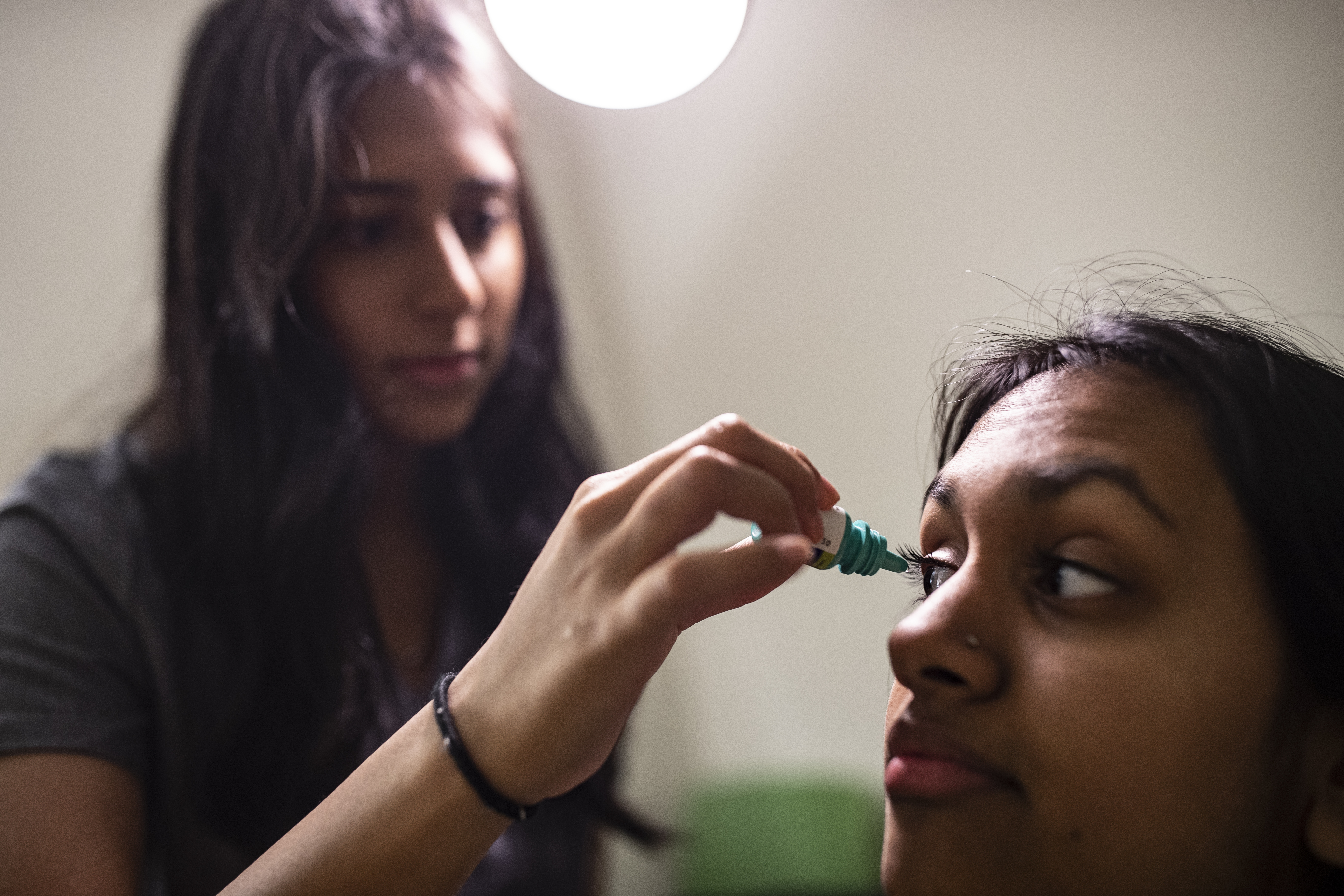 optometrist administering eye drops