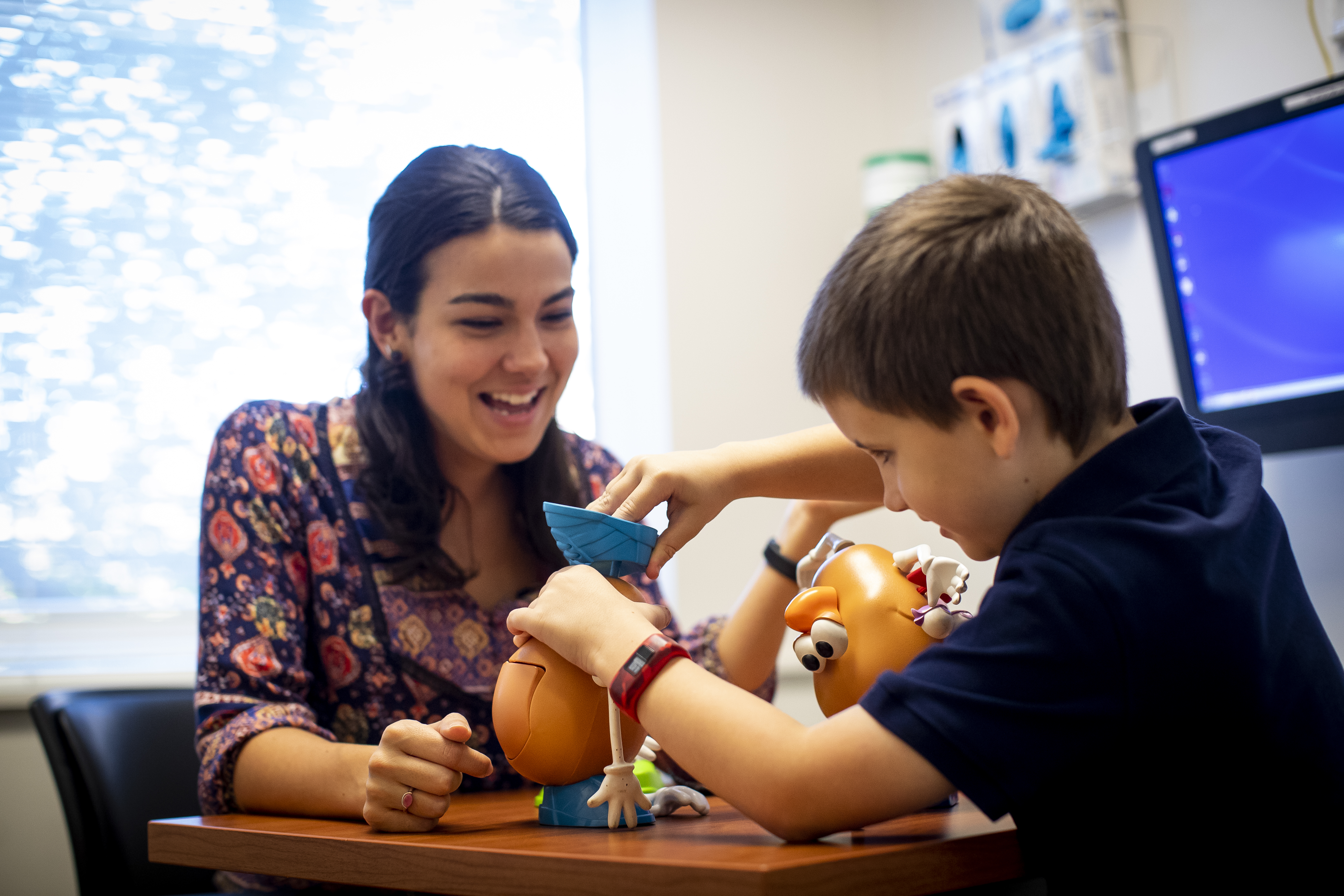 Pediatric client playing with toys at SLI