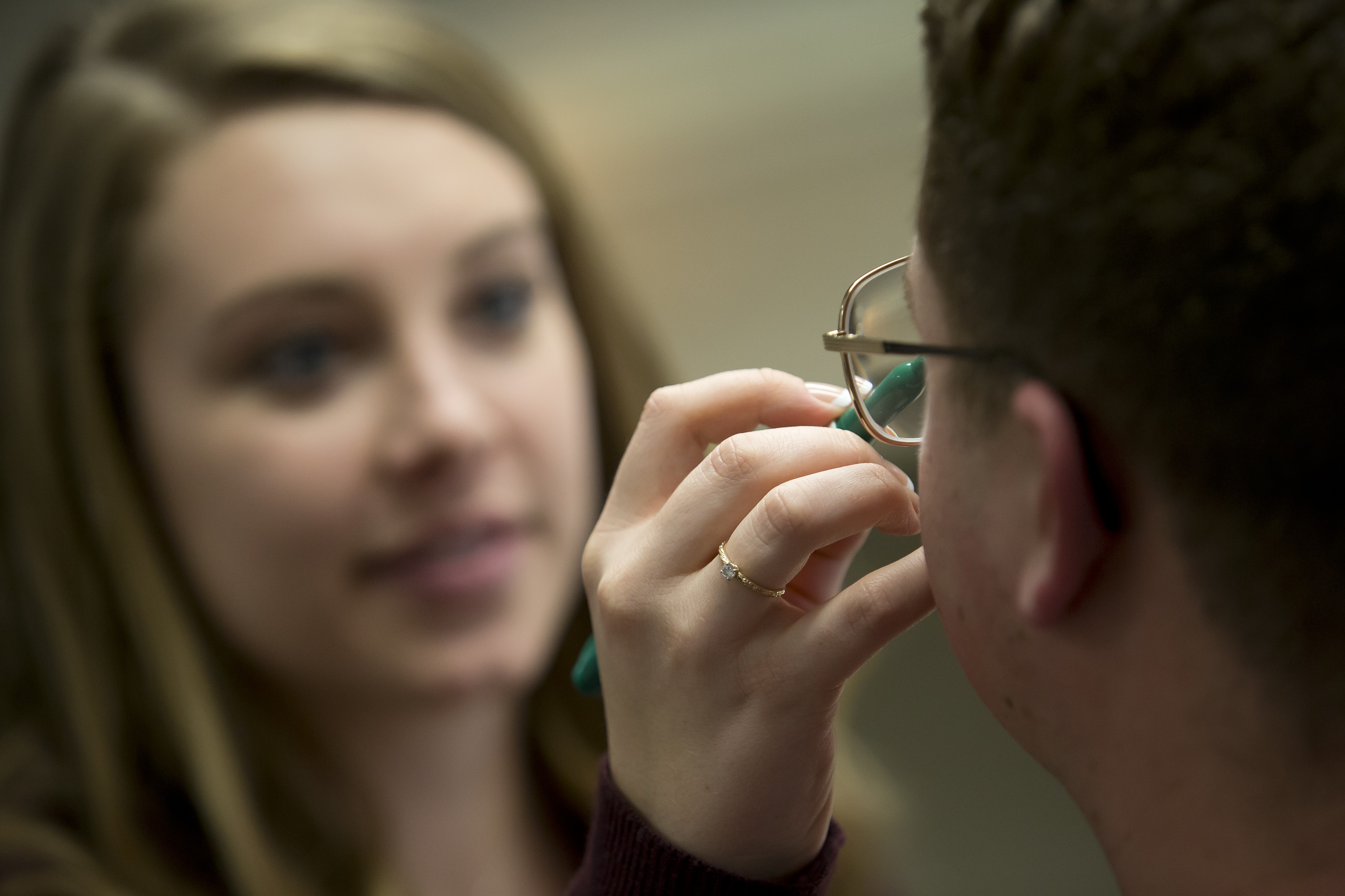 Student measuring patient's eye