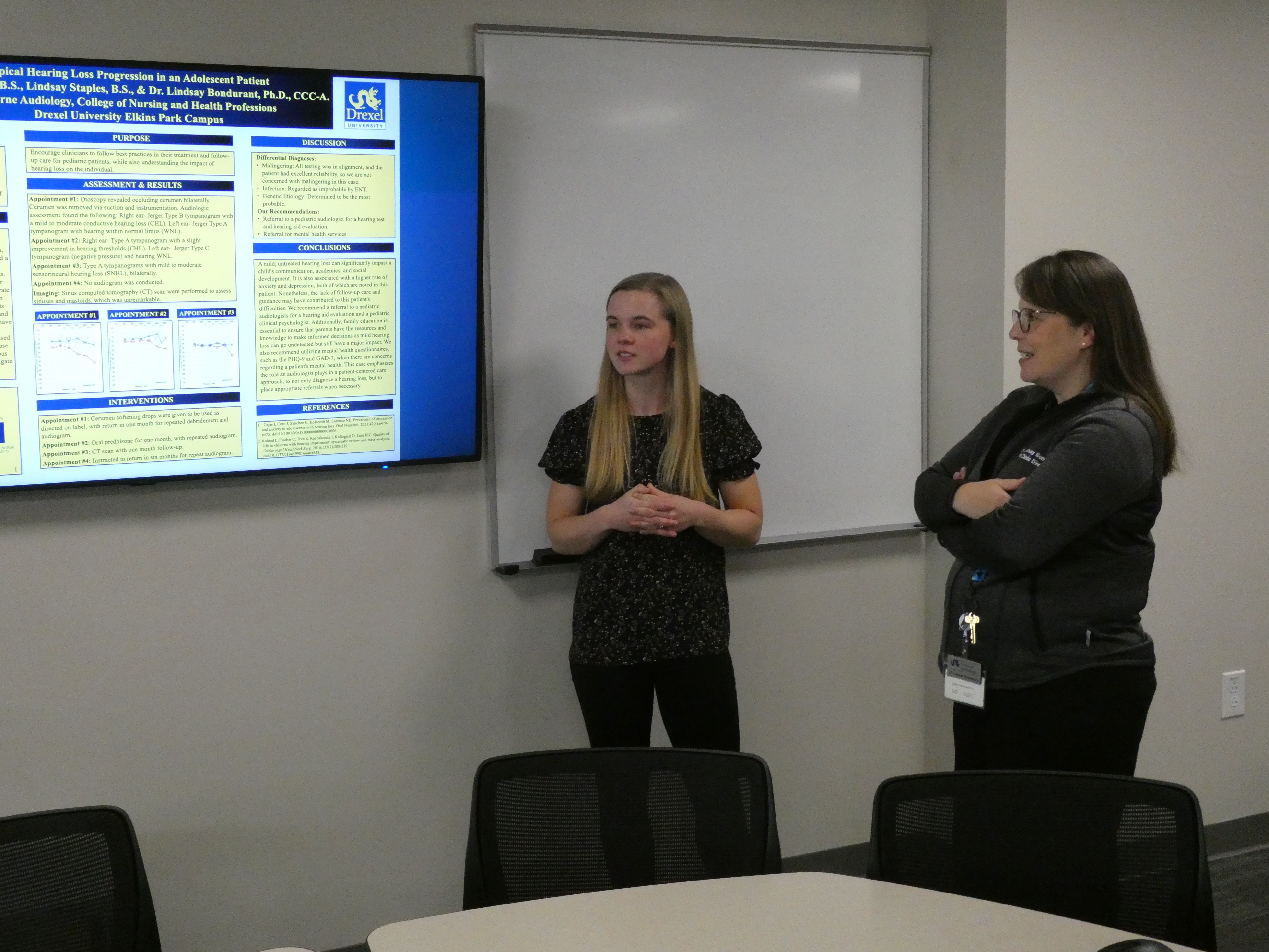 AUD student showing Dr. Bondurant her poster pic1