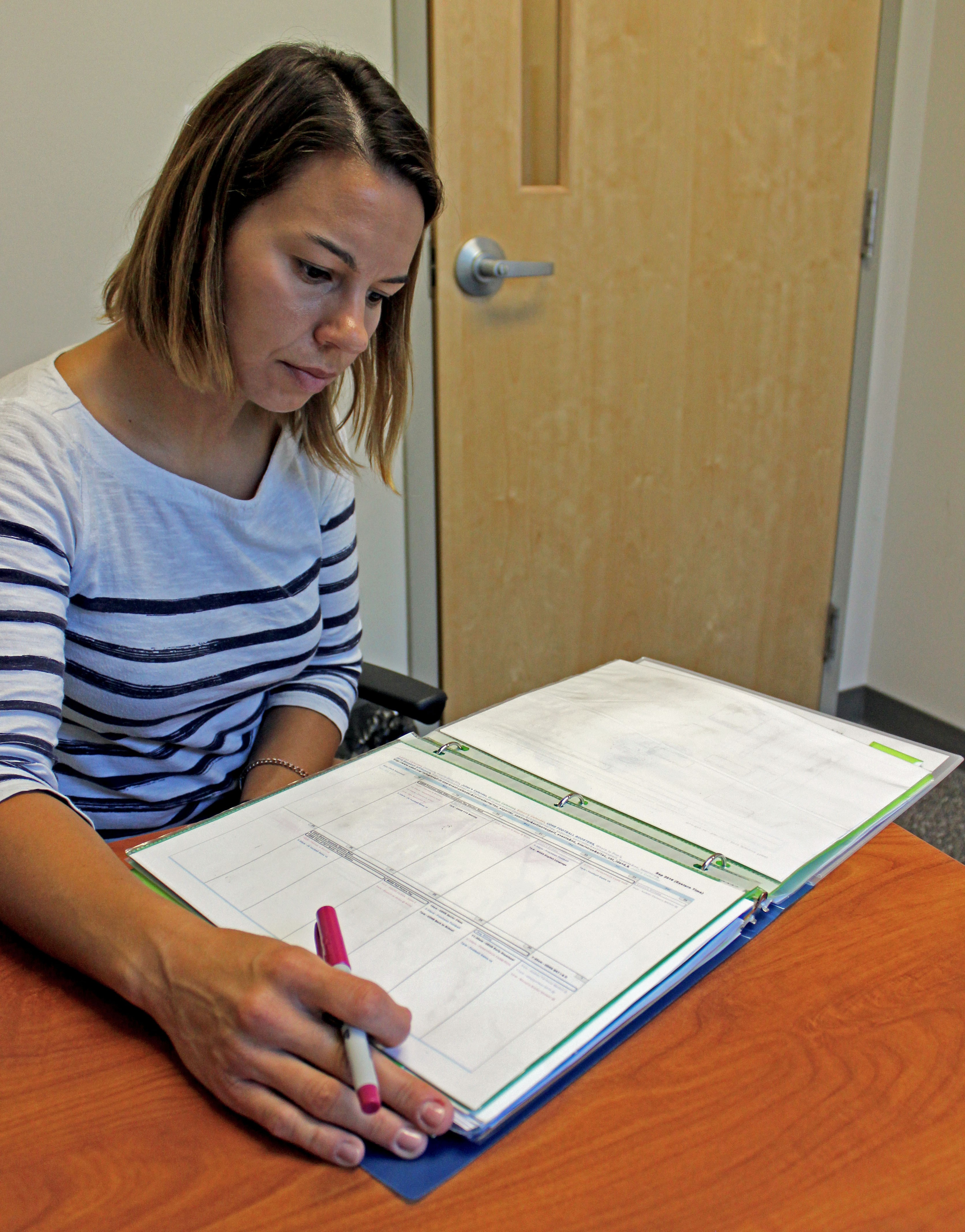 SLI patient at table looking at notebook
