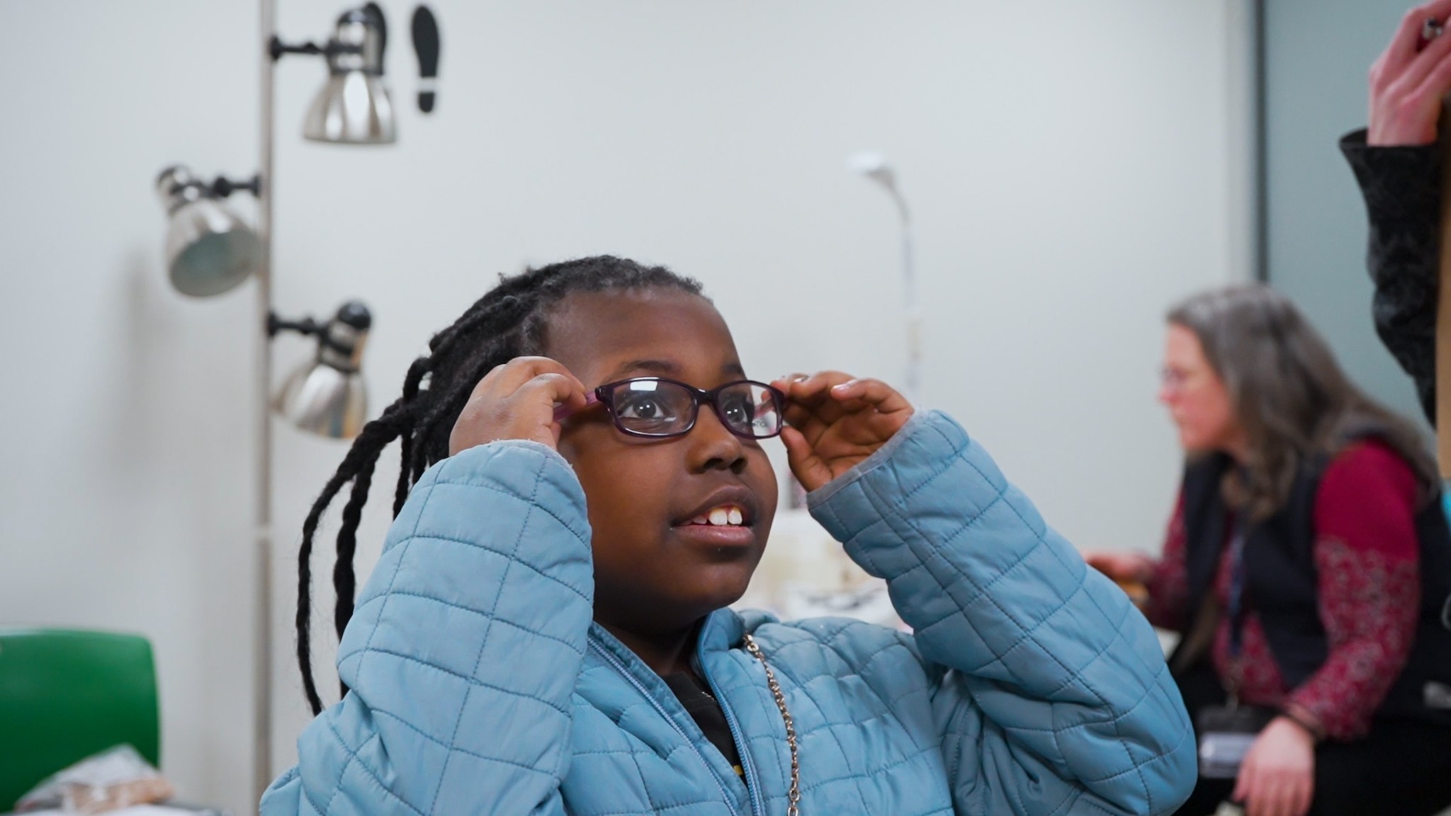 Young girl trying on glasses