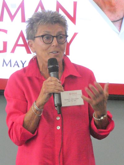 Dr. O speaking holding a microphone
