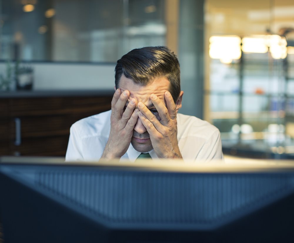 Man covering his eyes and face with his hands