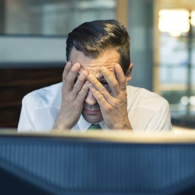 Man with both hands covering his eyes and face thumbpic
