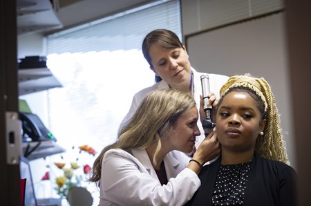 Patient getting an ear exam at PEI