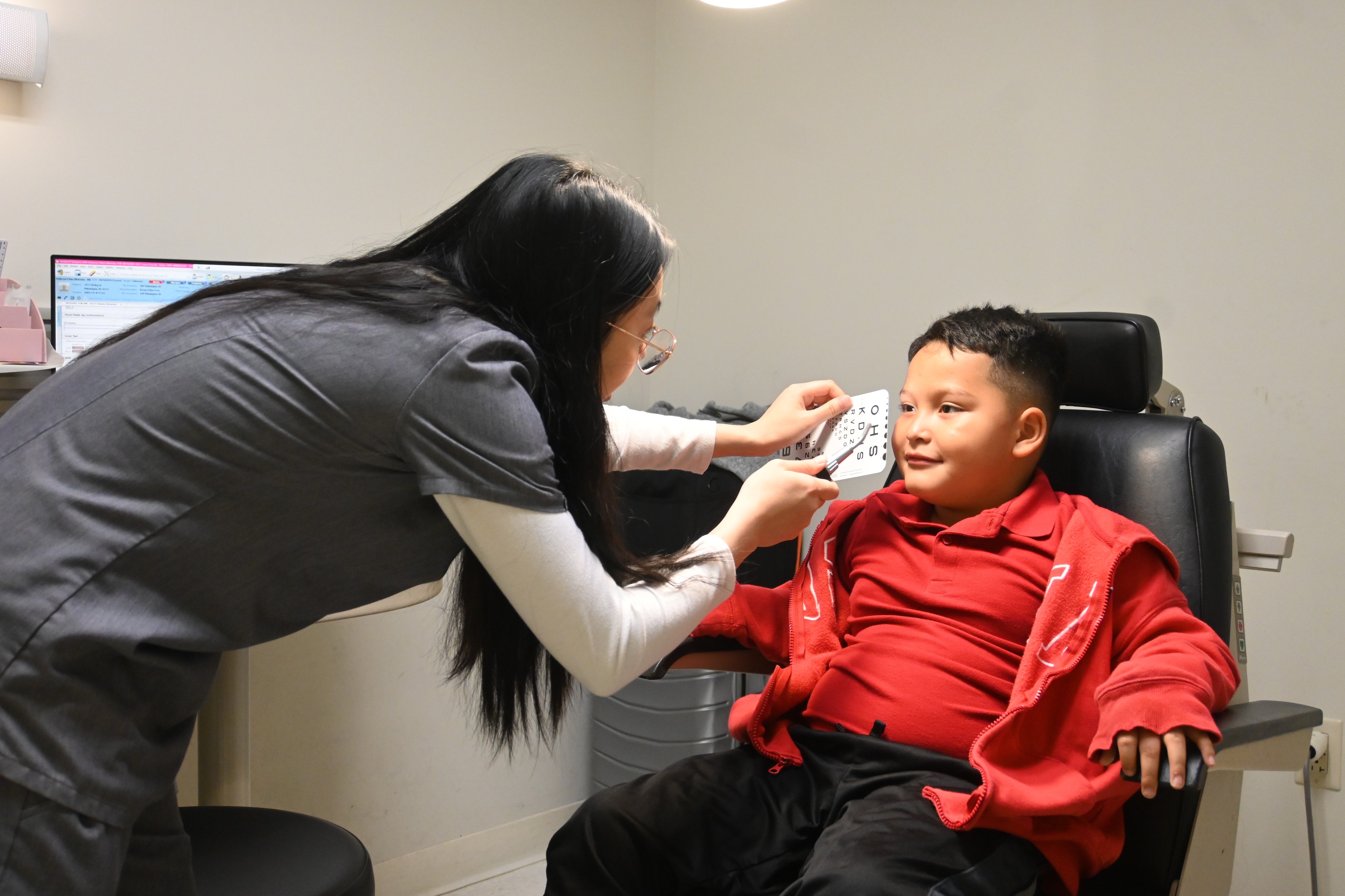 Schoolboy gets eye exam from PCO student