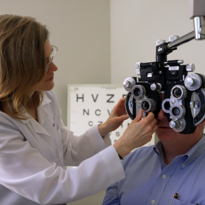 optometrist adjusting phoropter