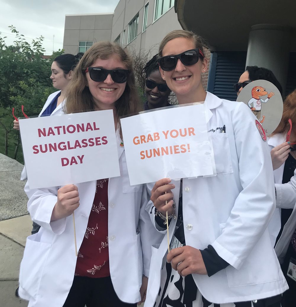 Two white coat students in sunglasses pic