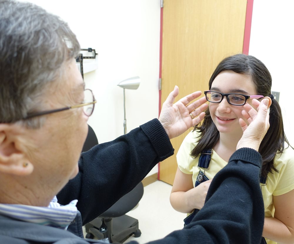 Female pediatric patient trying on glasses