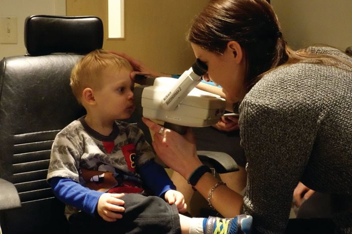 Student examines young patient at TEI