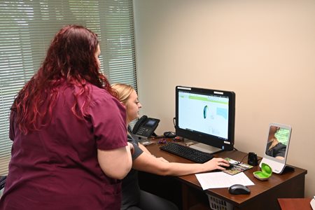 Audiologist teaching OCA student how to read results