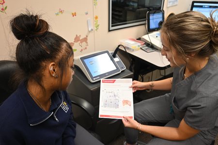 OCA student showing patient test results