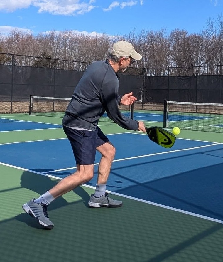 Pickleball player making a return shot pic