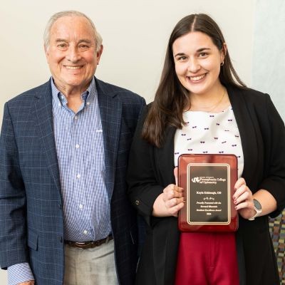 Dr. Kayla Eshbaugh and Dr. Bernard Blaustein with award thumpic