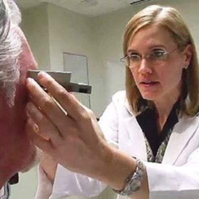 optometrist conducting eye exam