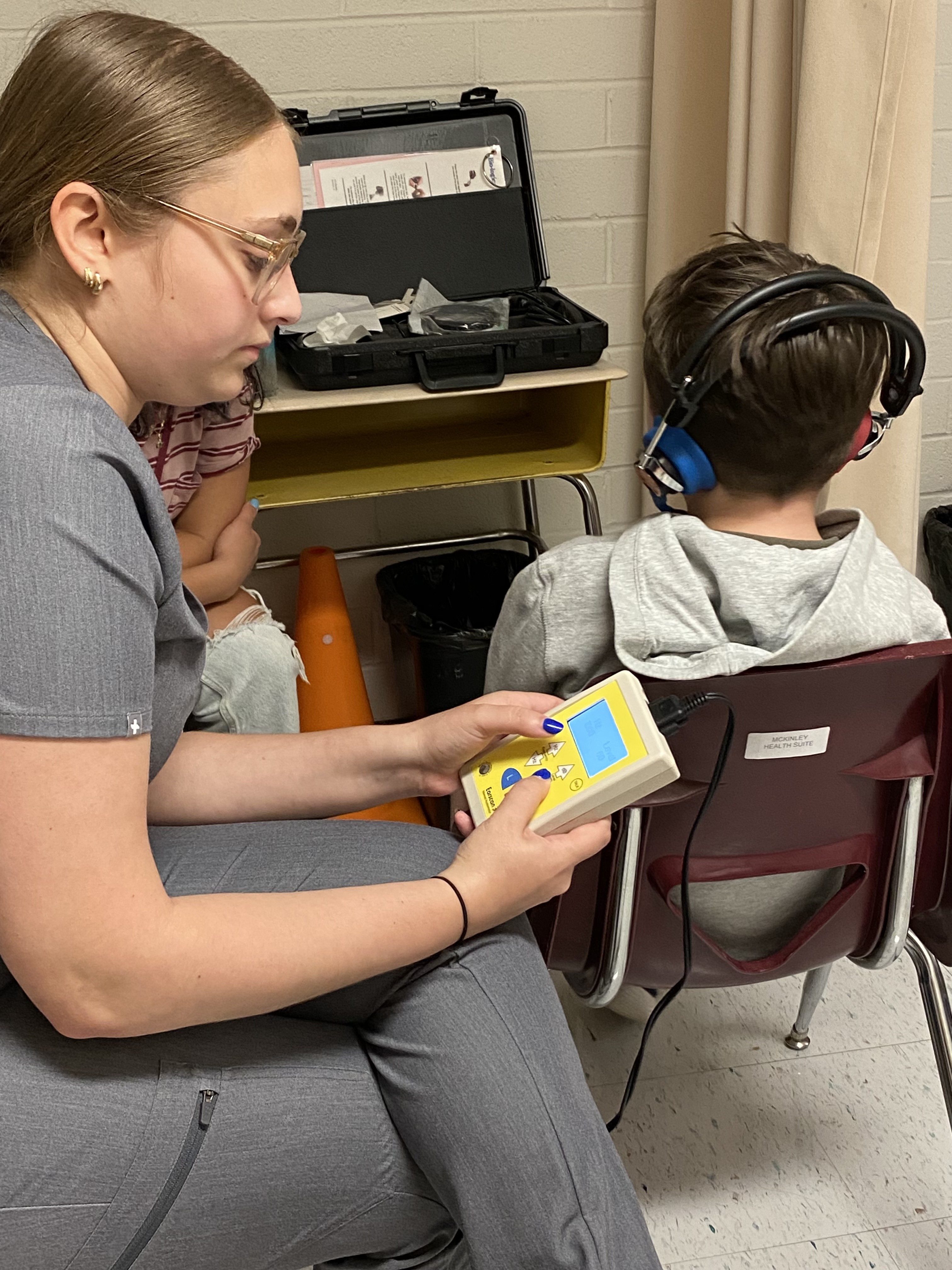 PEI student with young male patient in hearing lab pic2