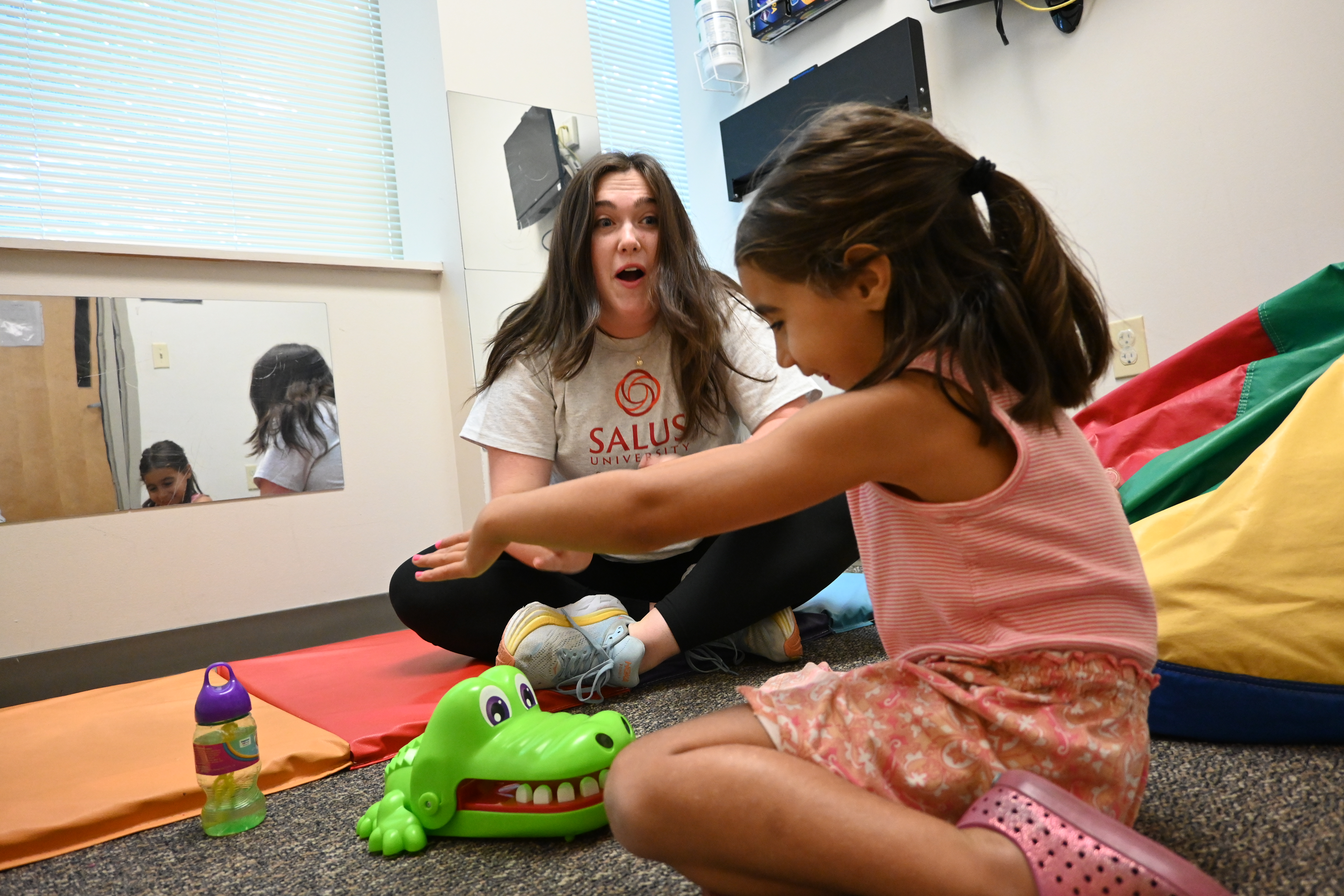 Child and SLI student playing with toys