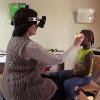 Dr. Elise Ciner examines young student thumbpic