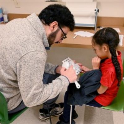 Resident with young student thumbpic