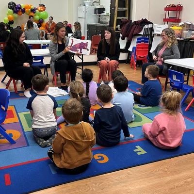 SLP students reading to children during an interactive story time