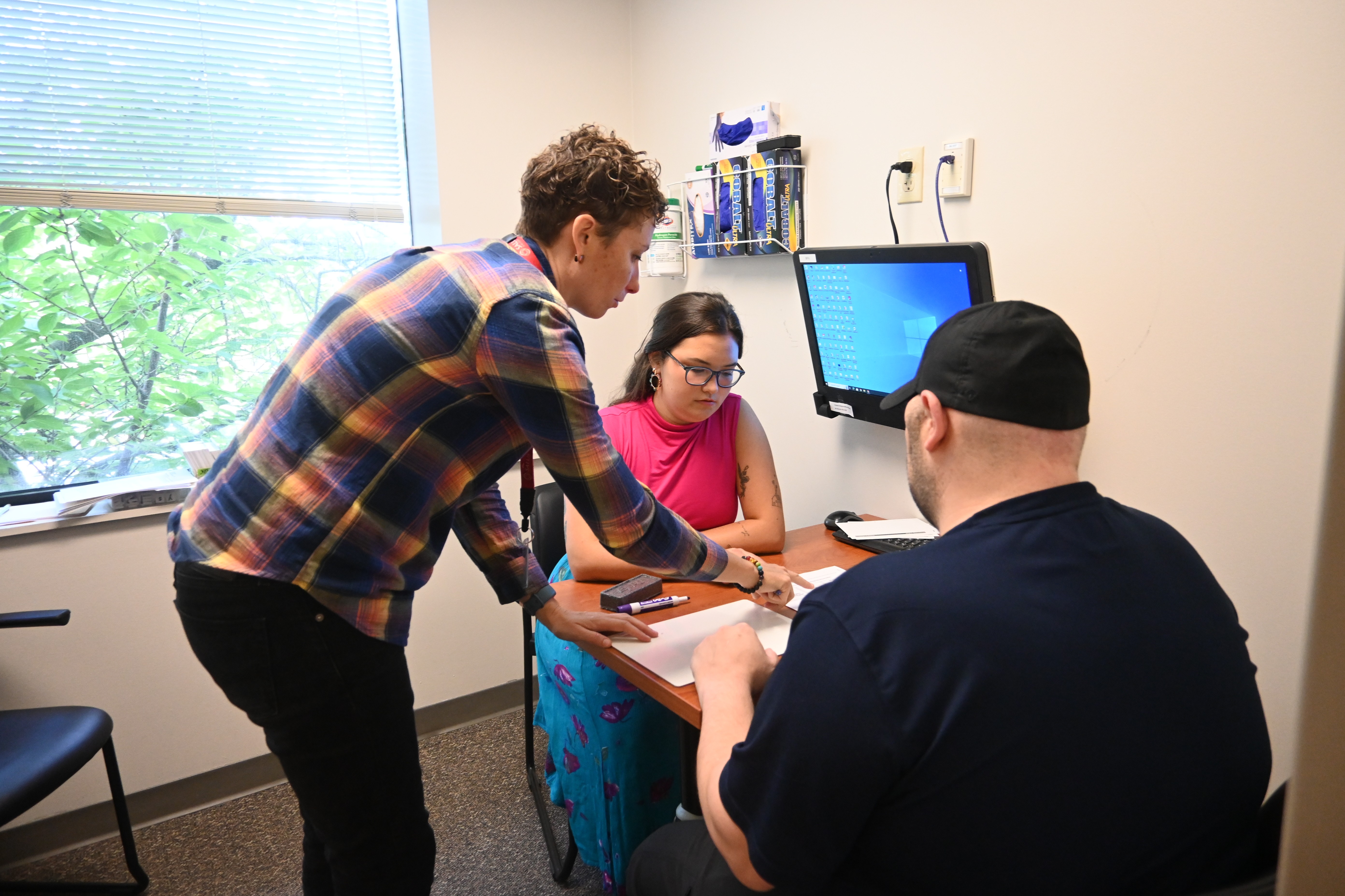Anne Ruckdeschal with client in exam room